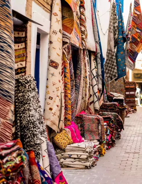 Street in Morocco with stores selling Morocco rugs.